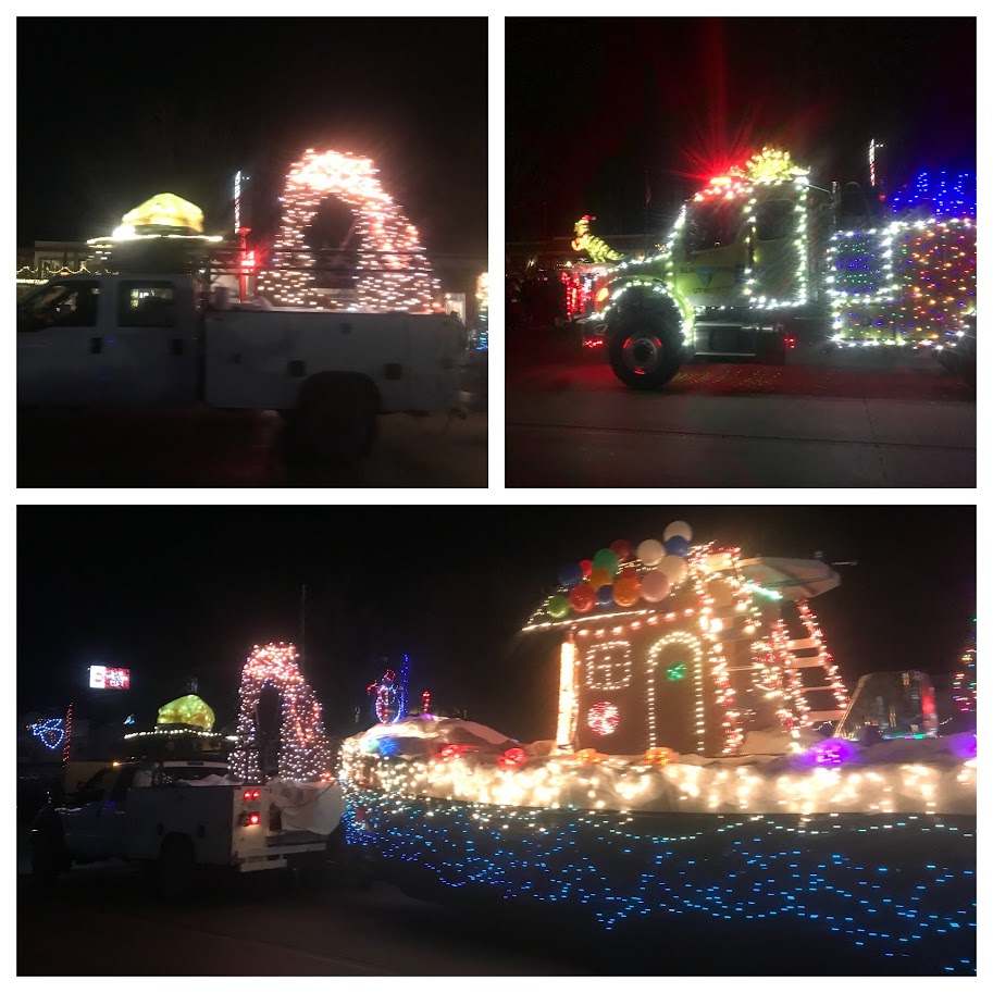The Electric Light parade shows floats with Delicate Arch, Dinosaurs, and a gingerbread house on a river raft