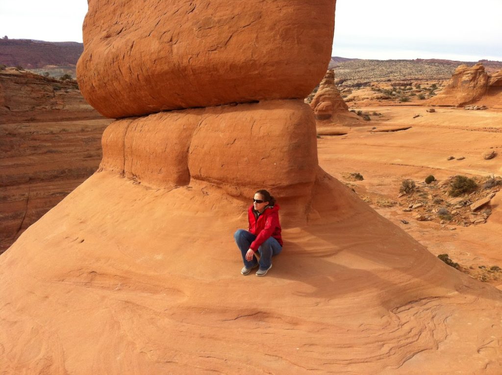 Lucy under Delicate Arch with no one around